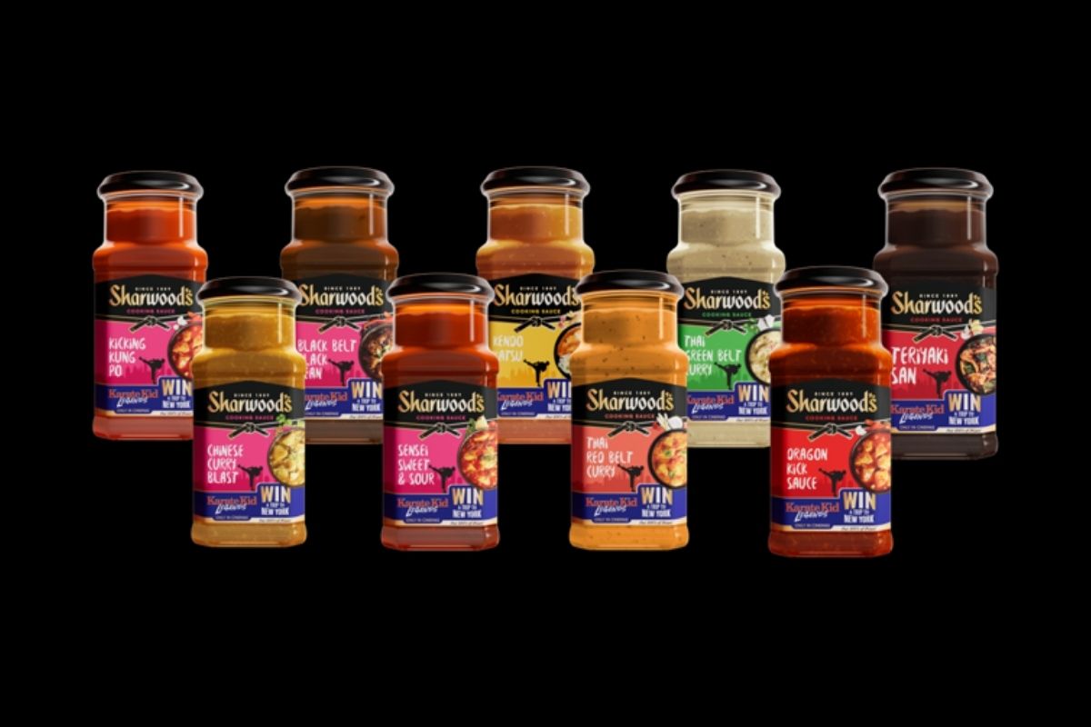 A lineup of Sharwood’s cooking sauce jars, featuring varieties like Kicking Kung Po, Chinese Curry Blast, Thai Red Belt Curry, and Teriyaki San, all promoting the Karate Kid-themed ‘Win a Trip to New York’ on-pack campaign.